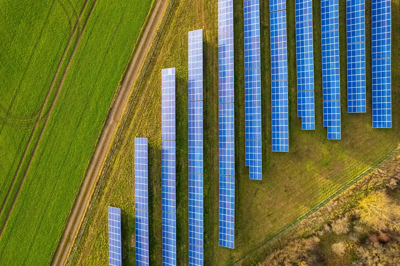 Aerial view of community solar array in a green agricultural landscape